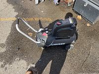 Overall view of black Husky horizontal air compressor with handle and wheels