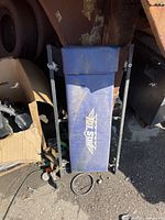 Front view of blue vinyl creeper showing logo and metal frame