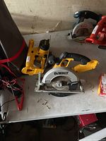Circular saw front view with jigsaw behind on workbench