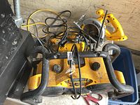 Top view of DeWalt radio, circular saw, router and cords