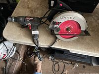 Craftsman drill and Skilsaw circular saw on table