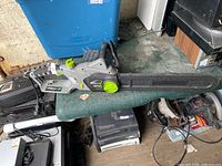 Left side view of Earthwise corded electric chainsaw, shows housing, handles and full bar with cover