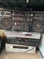 Front view of stacked boom box, DVD player, TEAC CD player and Yamaha receiver