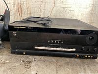 Front and top view of Harman/Kardon AVR 210 showing missing knob, buttons and inputs