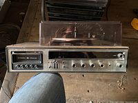 Front of stereo showing 8-track slot, tuner panel, control knobs
