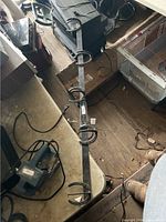 Full view of metal bar with five horseshoe hooks