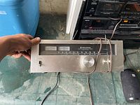 Front view of Kenwood tuner showing meters, dial, knob and switch