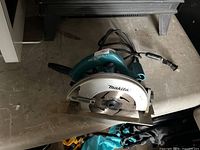 Top view of Makita corded circular saw showing handle, blade guard, and cord