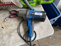 Blue and black Mastercraft corded drill with power cord on work surface