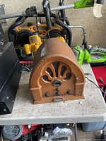 Front view of wooden cathedral radio showing dial, knobs, grille and nameplate