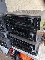 Stack of receivers and CD changer showing fronts and brands
