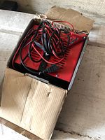 Red Powertech charger with cords inside box