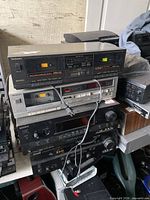 Stacked audio components showing two cassette decks and two receivers