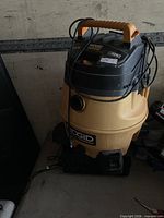 Overview of Rigid wet/dry shop vacuum showing full unit, cord, and missing hose