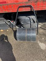 Full view of lawn roller showing drum and handle