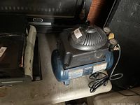 Mastercraft air compressor front and side view showing tank, motor housing, gauges and cord