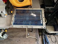 Top view of rectangular solar panel with frame and cord