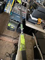 Full view of Sun Joe electric pole pruner chainsaw on workbench