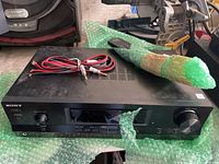 Top view of Sony receiver with remote and speaker wires on bubble wrap