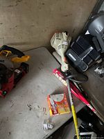 Trimmer powerhead and shaft on table