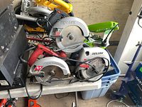 Stack of three Skilsaw circular saws on table