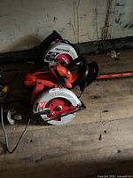 Stacked Craftsman circular saw, orange circular saw, cordless hedge trimmer