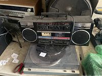 Front view of Fisher boombox sitting on Plus 200 turntable