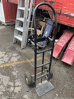 Full front view of hand truck showing frame, handle, wheels and base plate