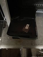 Two stacked black Xbox 360 S consoles showing fronts and tops