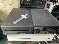 Top view of black original Xbox One stacked on white Xbox One S