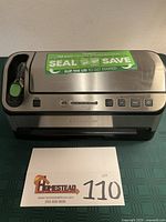 Front view of FoodSaver vacuum sealer showing stainless steel exterior and control panel