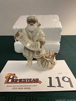 Front view of Lenox African American Santa figurine with scroll and toy bag