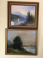 Pair of antique pastel paintings showing sailboats on a river in gold-painted ornate frames hung vertically on a wall