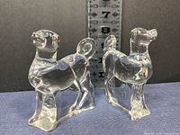 Pair of Baccarat crystal dog figurines displayed side by side measuring approximately 4.5 inches in height.