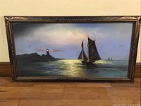 Full view of framed pastel showing sailboat and lighthouse scene