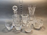 Full shot of 7 crystal items with measuring ruler showing sizes