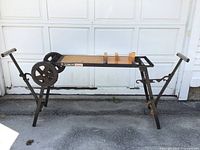 Delta Kickstand portable worktable fully set up and standing on pavement in front of white garage doors.