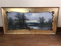 Full view of the framed pastel landscape showing the entire painting and the gold gilt frame.