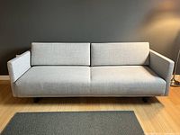 Front view of futon couch in sofa position against a wall.