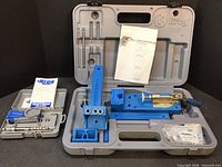 Open case showing Kreg pocket hole jig components including jig, clamp, drill bit, manuals, and accessories all organized in molded compartments.