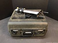 Closed hard plastic molded carrying case with Porter-Cable label on front, black textured with latches and handle.