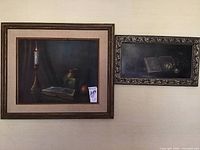 Full view showing both framed paintings side by side on a wall to depict size difference and framing.