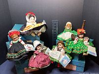 Six Madame Alexander country dolls posed with original blue boxes, showing general lot contents.