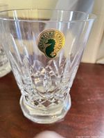 Single Waterford Lismore footed tumbler with brand seahorse sticker