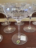 Single saucer champagne glass showing cut diamond and wedge pattern on bowl, slim stem and round base