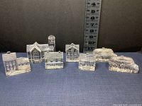 Seven crystal buildings arranged in line with ruler background