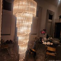 Full view of tiered spiral chandelier lit in room