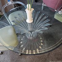 Full view from above showing round glass top and radiating lucite base