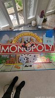 Box top with Monopoly Deluxe Edition logo and Mr. Monopoly mascot, showing box condition and game branding.