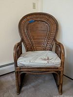 Front view of bamboo armchair with curved backrest and cushion